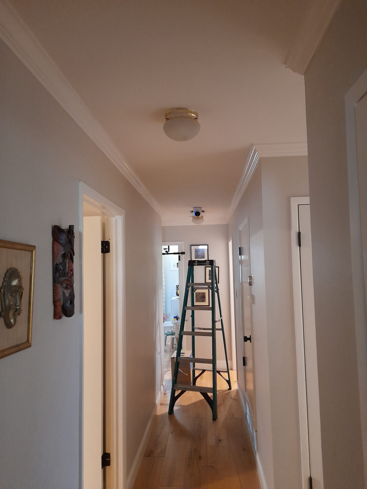 Small indoor camera mounted on a hallway ceiling